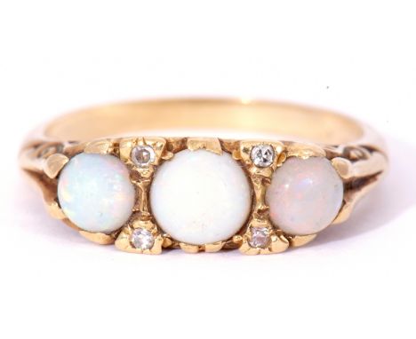 18ct gold opal and diamond ring featuring three graduated round cut cabochon opals, with four small diamond assents, all in a