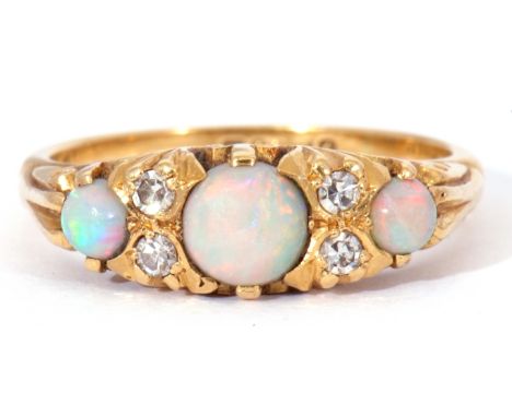 Mid-20th century 18ct gold opal and diamond ring featuring three graduated round cut cabochon opals, interspersed with four s