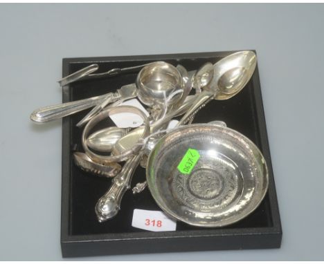 A miscellaneous collection of silver comprising a silver bangle, asparagus tongs, a pierced  ladle, four apostle spoons, a bu