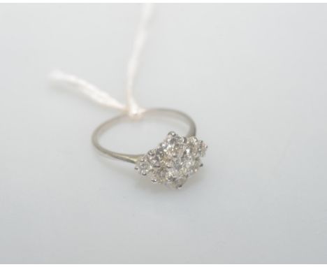 A diamond cluster ring set in white gold (unmarked), the brilliant cut diamonds totalling approx. 1.4cts, size K