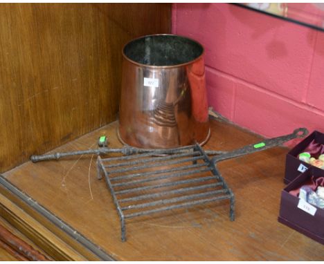 A cast iron griddle and tapered copper planter