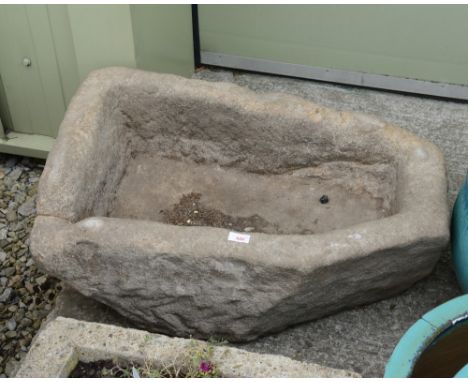 A large weathered stone planter