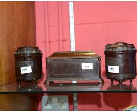 A group of 1930s bakelite storage containers comprising: sarcophagus form caddy, tea caddy and matching tobacco jar (3)