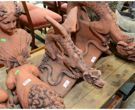 Composition garden ornaments: a small roof ridge tile of a dragon preparing to fly