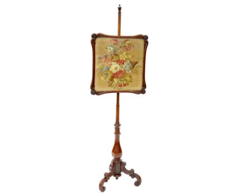A VICTORIAN MAHOGANY POLE SCREEN ON CARVED BASE WITH EMBROIDERY WORK PANEL