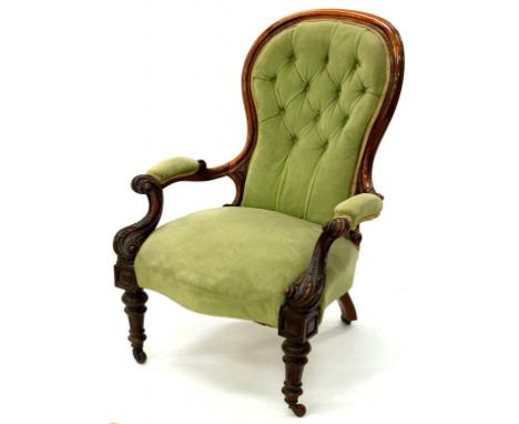 A VICTORIAN CARVED WALNUT ARMCHAIR UPHOLSTERED IN GREEN BUTTON BACK FABRIC 