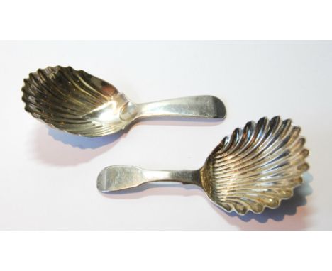Silver scallop caddy spoon by Lindsay Beech (Glasgow), 1807, and another similar, Edinburgh 1825.   (2) Condition Report No c