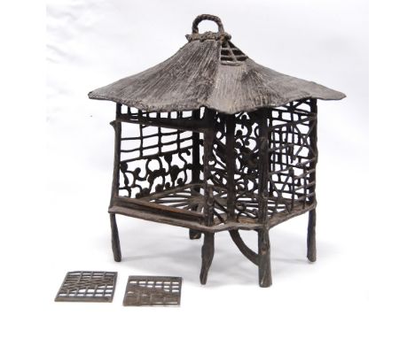 Oriental cast bronze pierced lantern in the form of a pavilion on stilt legs, 33cm high.