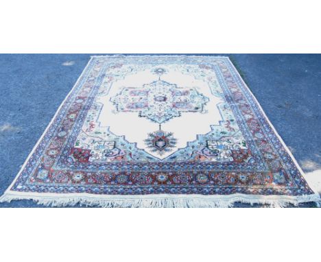 Persian design carpet with thick wool pile, central floral medallion, cream ground spandrels and group border, 308cm x 236cm.