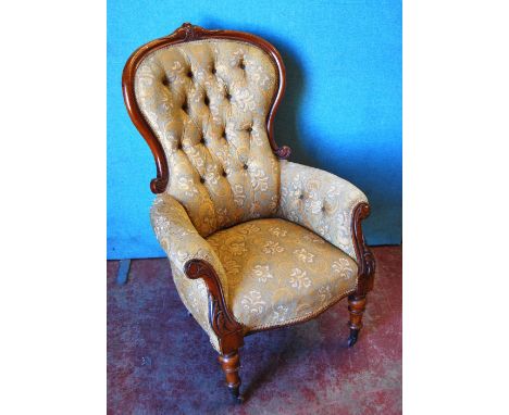 Victorian mahogany framed button-back armchair with scroll arms, serpentine seat and raised on tapering baluster turned legs 