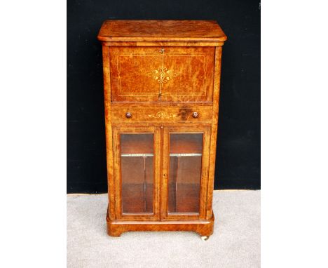 Late Victorian figured walnut music cabinet, the boxwood strung quarter veneered top over inlaid fall flap enclosing simple f