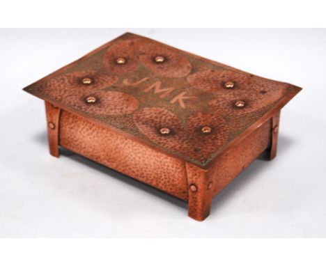 Copper Arts & Crafts box of rectangular form on four bracket feet, the hammered ground with the initials 'JMK', heart motifs 