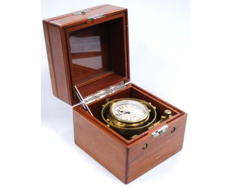 Waltham brass chronometer clock, gimballed box, the dial 6cm diameter. Condition Report Winds up.  Spring and balance is good