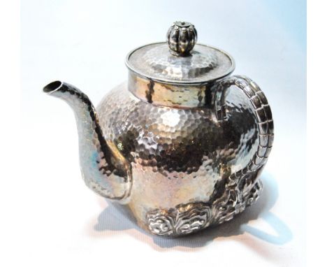 Chinese export silver teapot, possibly by Tu Mao Xing of rounded square shape, hammered, with chased twigs, rocks and blossom