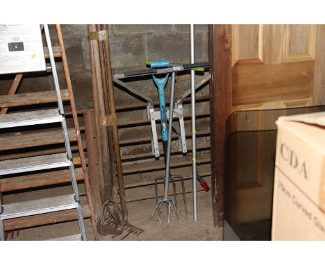 A ladder stay, long handled pruner and a fork etc