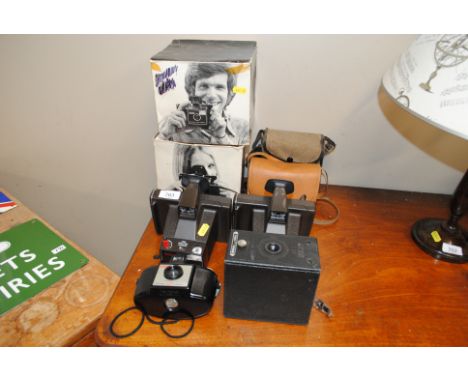 Two polaroid cameras, a kodak brownie camera and a box camera