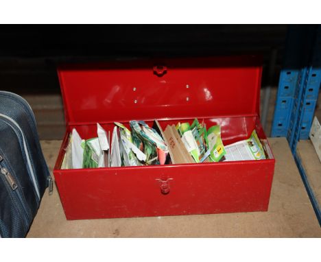 A red metal tool box and contents of various seeds