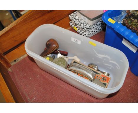 A box containing various pipes, rolls razor, harmonica etc