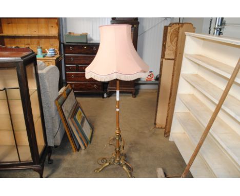 A brass Art Nouveau standard lamp and shade