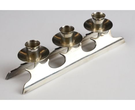 A fully hallmarked sterling silver three branch candlestick, maker marked for Mairi Bugg and assay marked for London. 