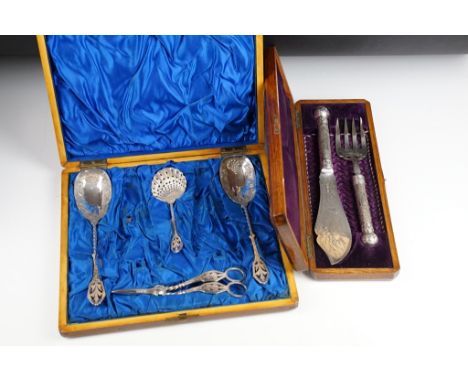 Two cased silver plated serving sets to include serving spoons, fish knife, bread fork, grape scissors...etc. 