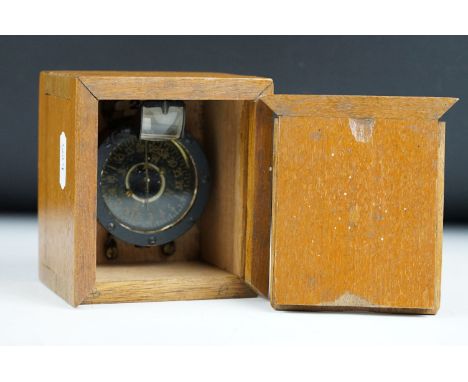 A military Naval compass set within a wooden case. 