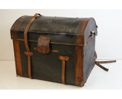 19th Century dome topped steamer trunk having a black body with brown leather banding and straps and hinged top. 