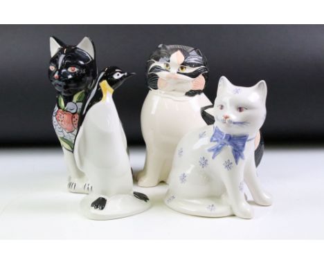 Group of four ceramic animals to include a Goebel cat, a Poole pottery penguin, Rye pottery cat and a pottery cat being hand 