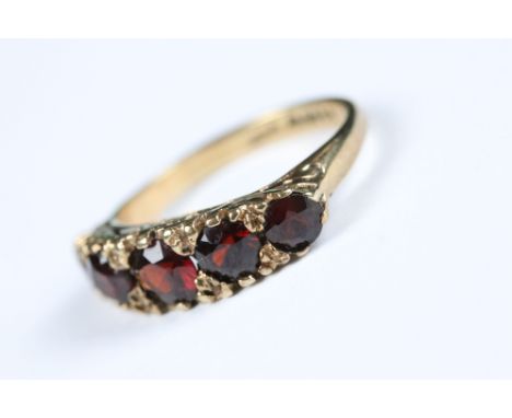 A fully hallmarked 9ct gold ladies ring set with five graduated garnets. 