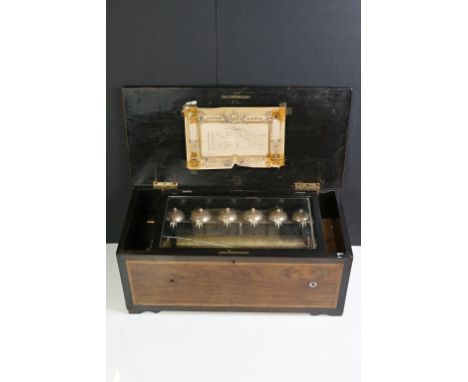 19th Century Swiss music box with eight airs, rosewood case, the inlaid hinged lid with marquetry lyre and floral motif, band