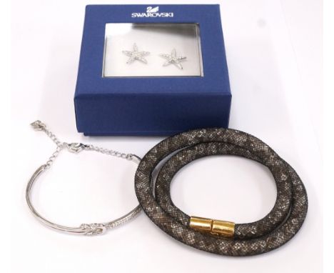 THREE PIECES OF SWAROVSKI JEWELLERYcomprising a Stardust Light double bracelet; a crystal set bangle with knot detail; and a 