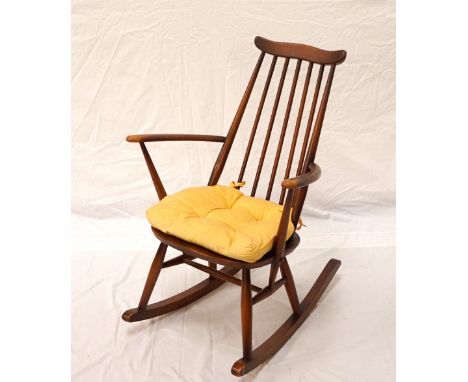 ERCOL ROCKING CHAIRwith a shaped top rail above a stick back with shaped arms and an elm seat 