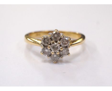 DIAMOND CLUSTER RINGon eighteen carat gold shank, the seven diamonds totalling approximately 0.5cts, ring size L