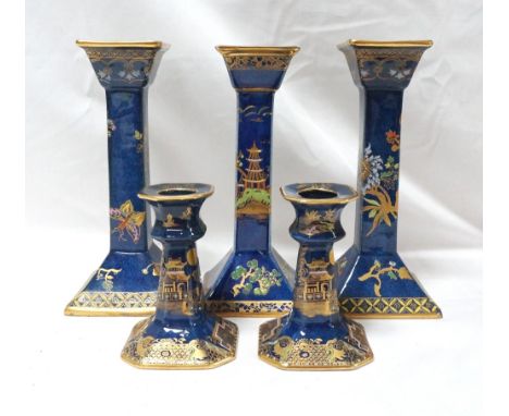 PAIR OF CARLTON WARE CANDLESTICKS of blue and gilt ground decorated with butterflies and flowers with the gold back stamp, 19