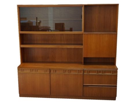 MCINTOSH & CO TEAK DISPLAY CABINET with a pair of smoked glass sliding doors above a shelf, with a pull down flap above two s