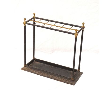 CAST IRON OBLONG STICK STANDwith brass finials above twelve divisions with a drip tray below, 60cm high Note: This lot is the