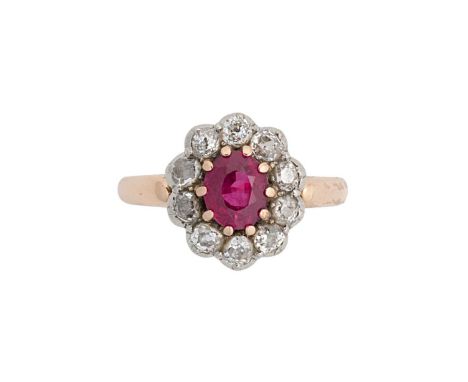 An 18ct gold ruby and diamond cluster ring, claw set oval faceted ruby, approximately 6.6 x 5.4mm, estimated approximate weig