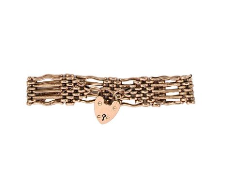 A gate style bracelet, five rows of textured and plain polished links, length 18cm, width 1.7cm, padlock heart clasp, unhallm