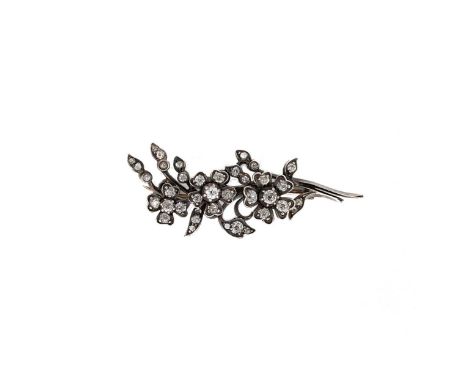 A diamond set floral spray brooch, estimated approximate total diamond weight (one diamond lacking) 0.90ct, the two larger fl