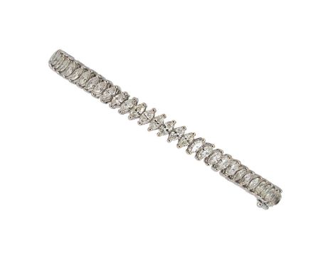 A diamond set bangle, thirty claw set marquise cut diamonds, estimated approximate weight 3.00ct, inside diameter 6.7cm, widt