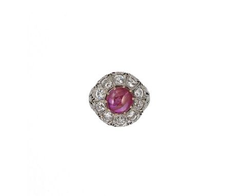 A cabochon ruby and diamond cluster ring, claw set round cabochon ruby (possibly Burmese), approximate diameter 10.5 x 10.2mm