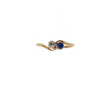 A sapphire and diamond crossover ring, old European cut diamond, estimated approximate weight 0.12ct, and an oval faceted sap