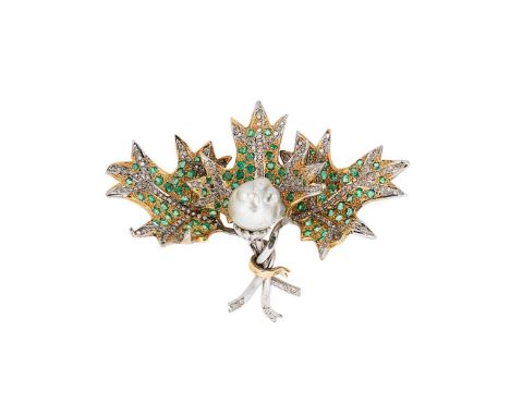 A pearl emerald and diamond holly brooch, central baroque pearl, approximately 10.5mm, surrounded by round faceted emeralds a