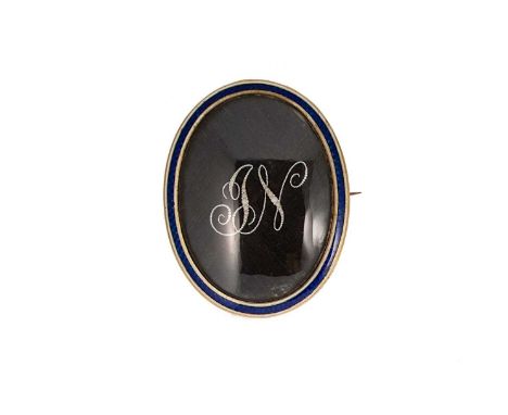 A Georgian mourning brooch, oval shaped with neatly woven hair and a seed pearl monogram, surrounded by blue and white enamel