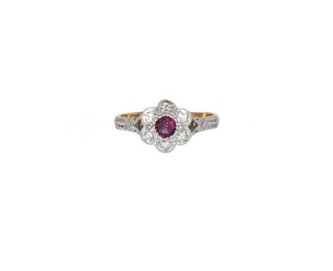 A ruby and diamond daisy style cluster ring, round faceted ruby, estimated approximate weight 0.30ct, surrounded by six eight