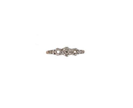 A three stone diamond ring, three illusion set diamonds, estimated approximate total diamond weight 0.11ct, size N, hallmarke