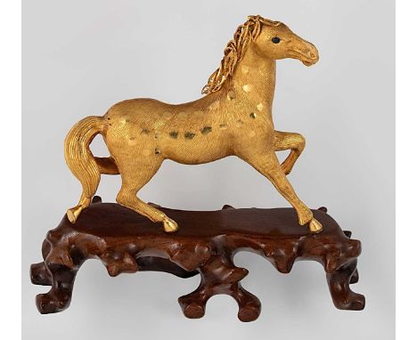 An Asian metalwares ornament in the form of a horse, indecipherable mark to the hind sole, no further apparent marks, tests a