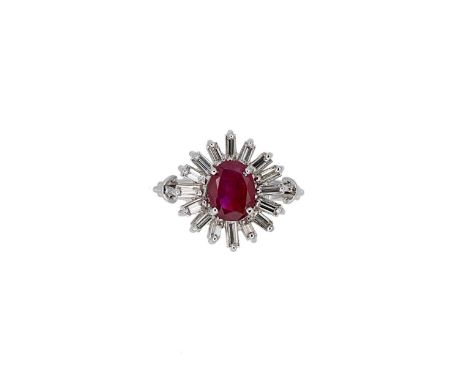 A Burmese ruby and diamond cluster ring, claw set oval faceted ruby, surrounded by sixteen baguette cut diamonds, estimated a