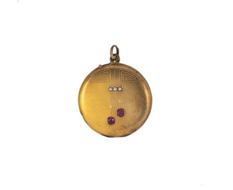An early 20th century ruby and split pearl locket, round with geometric engraving, set with two oval faceted rubies and three