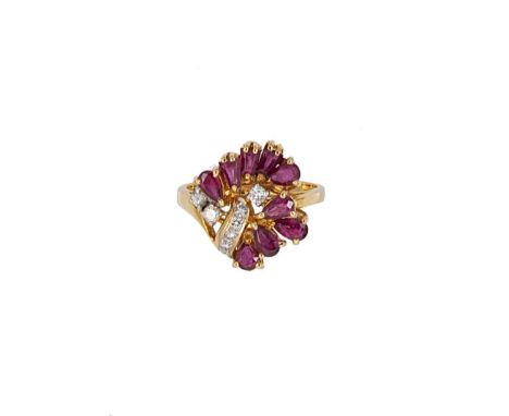 A modern ruby and diamond dress ring set with six pear shaped and three tapered step cut rubies, further set with eight round